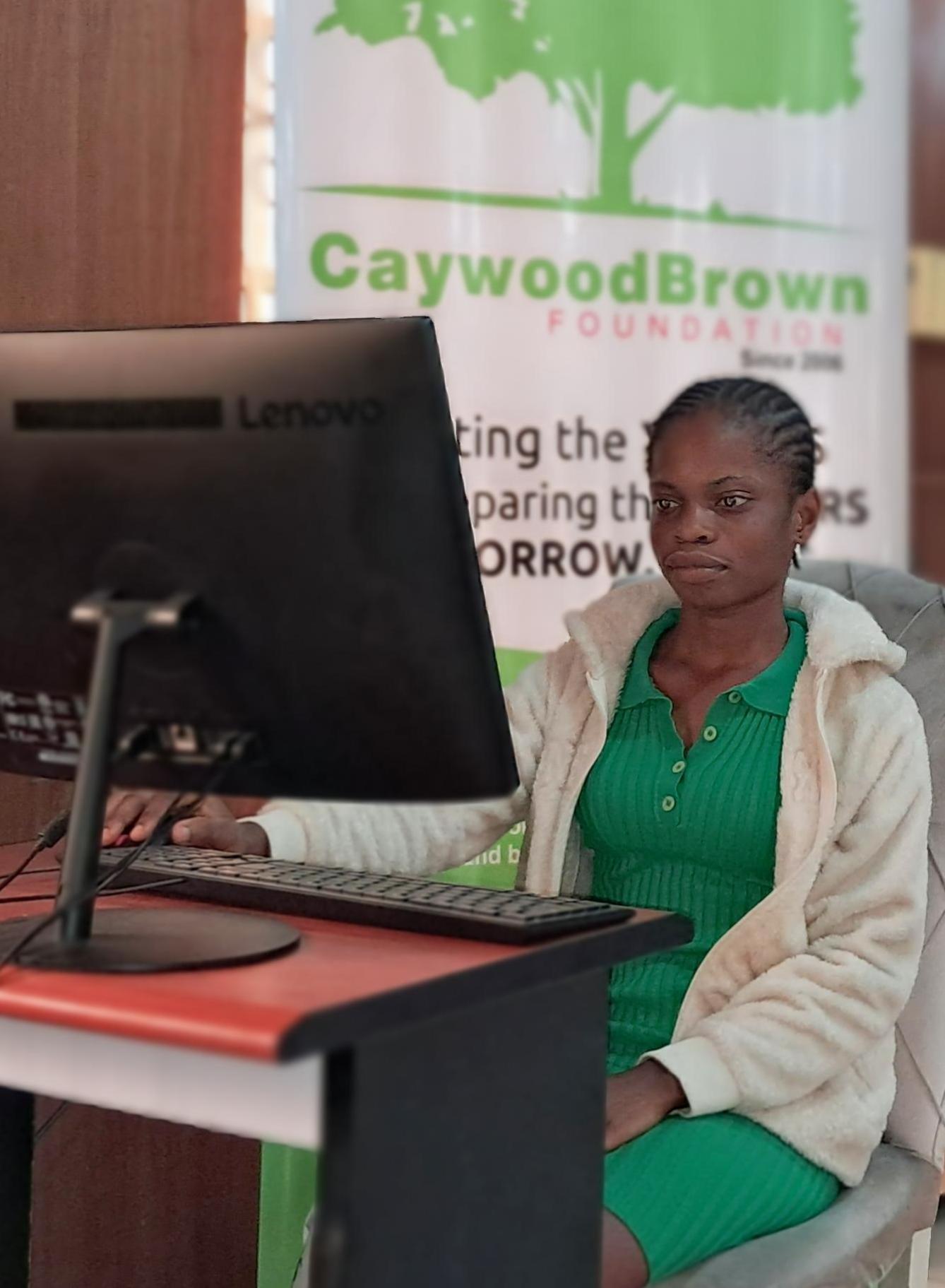 A young woman learning at a Caywood Brown computer workstation